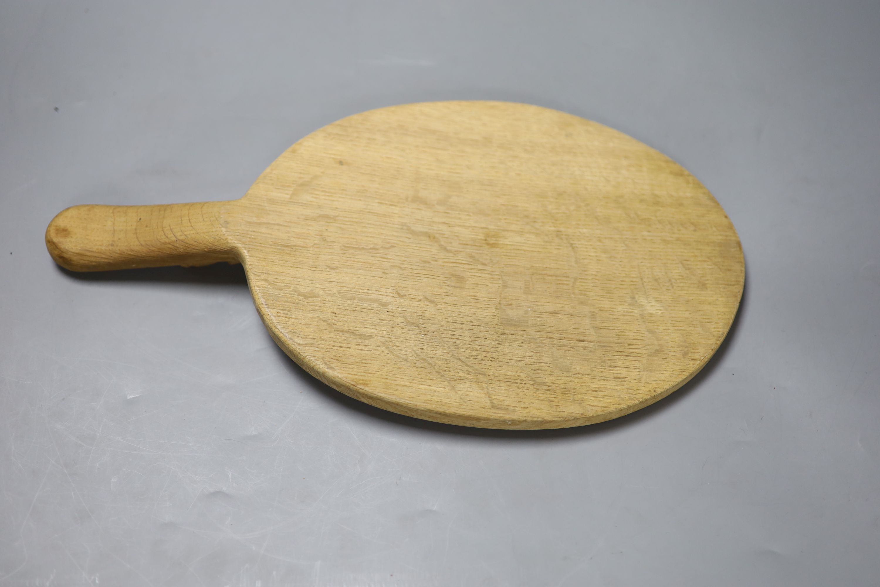 A Robert Thompson, The Mouseman, an oval oak cheese board, length 38cm